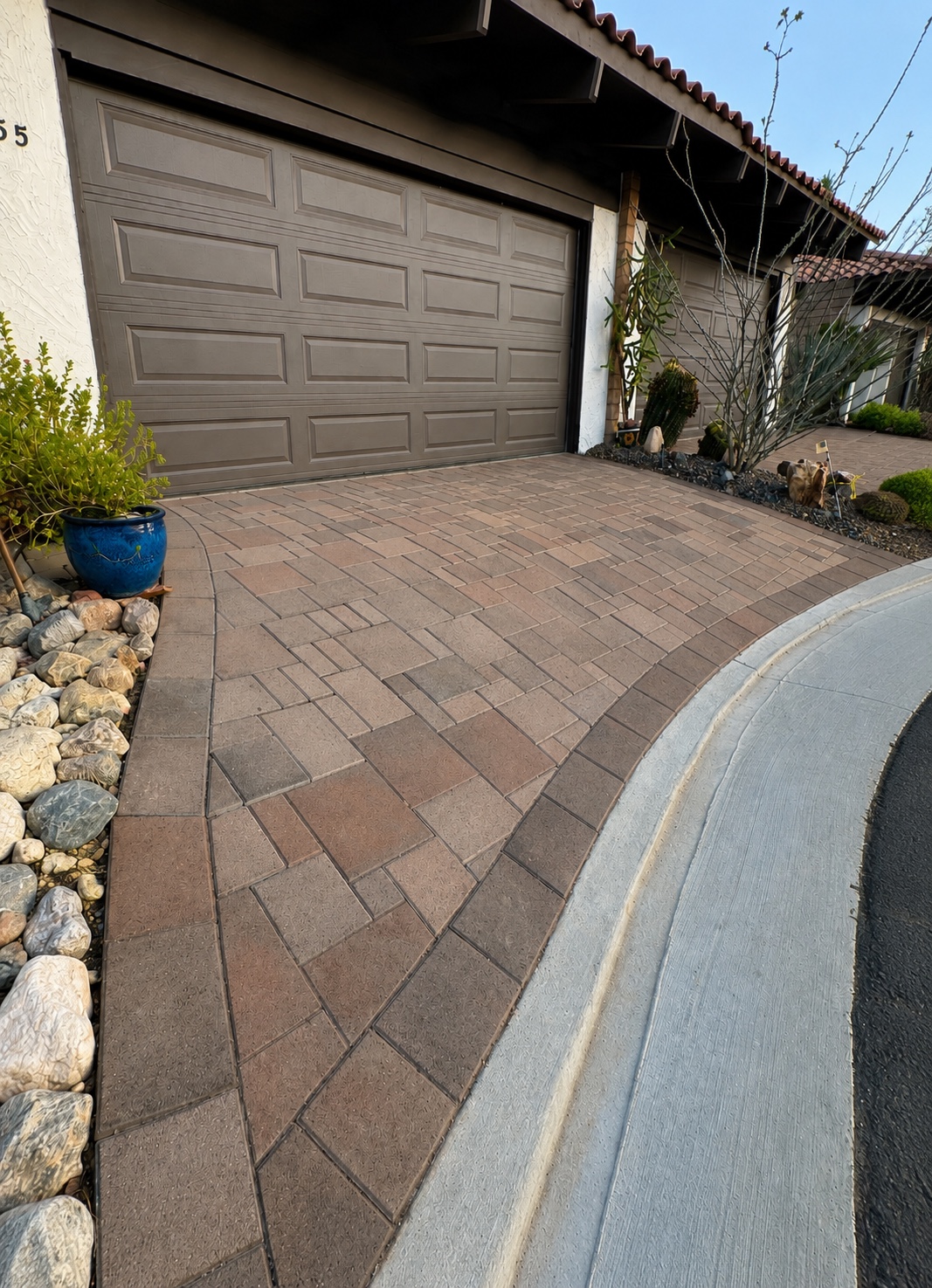 Driveway pavers before pressure washing — dust and grime dulling the pavers in front of a closed garage