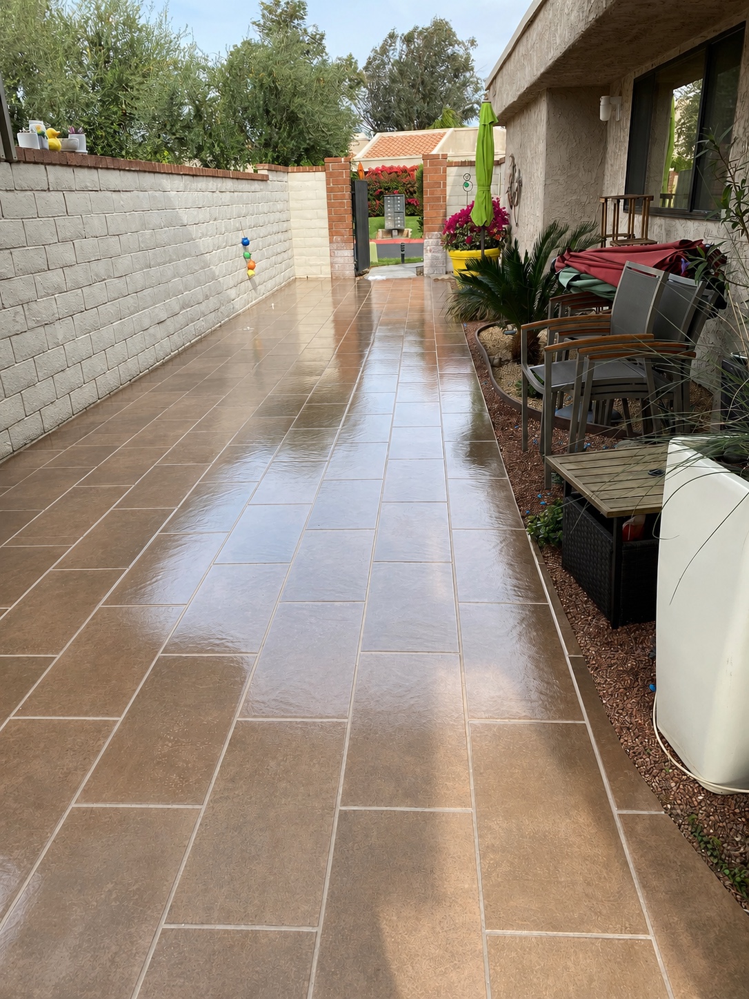 Same patio after pressure washing — tiles restored to vibrant tone, fresh and clean