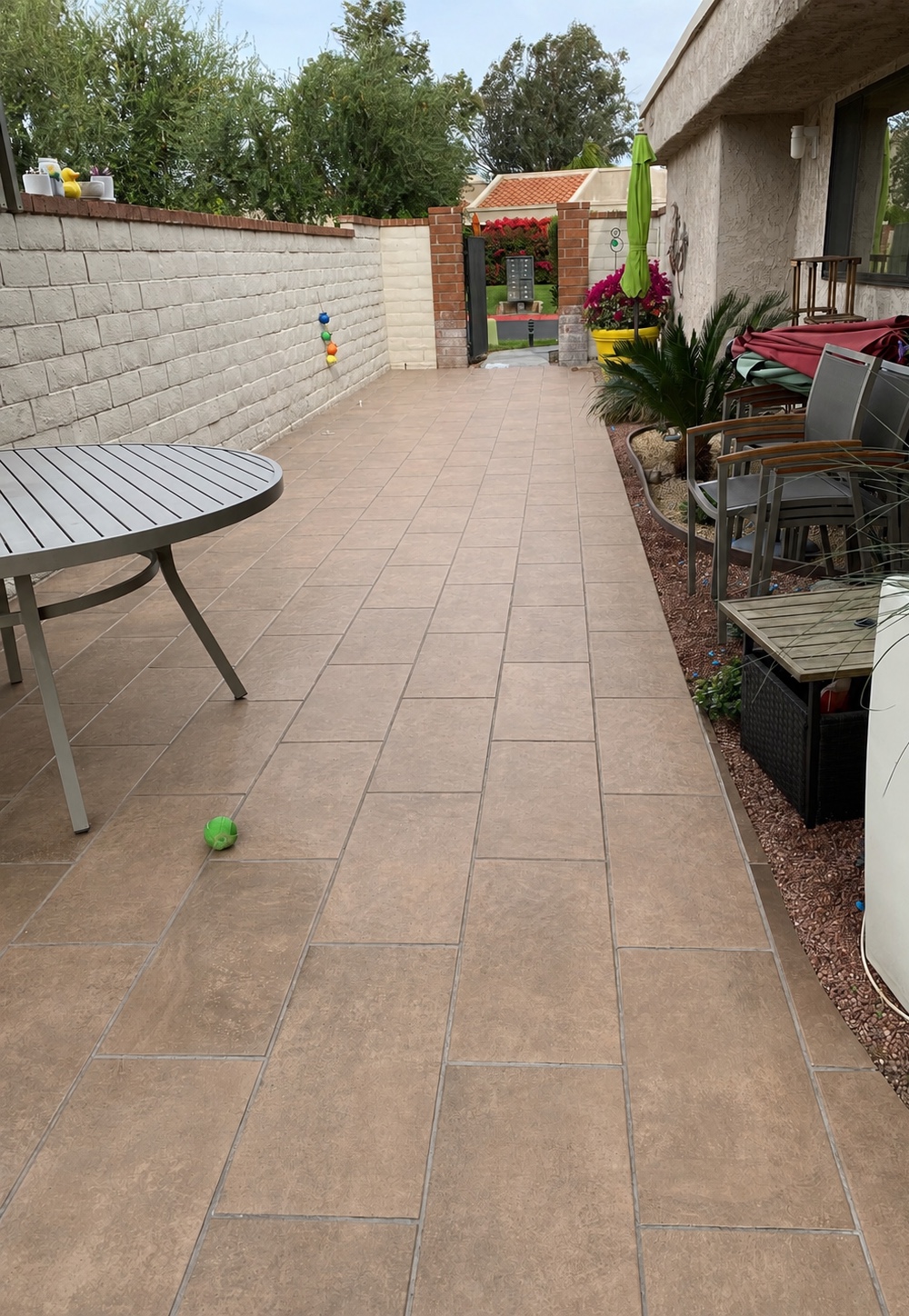 Patio tile before cleaning — dry with dulled grout lines and surface streaking