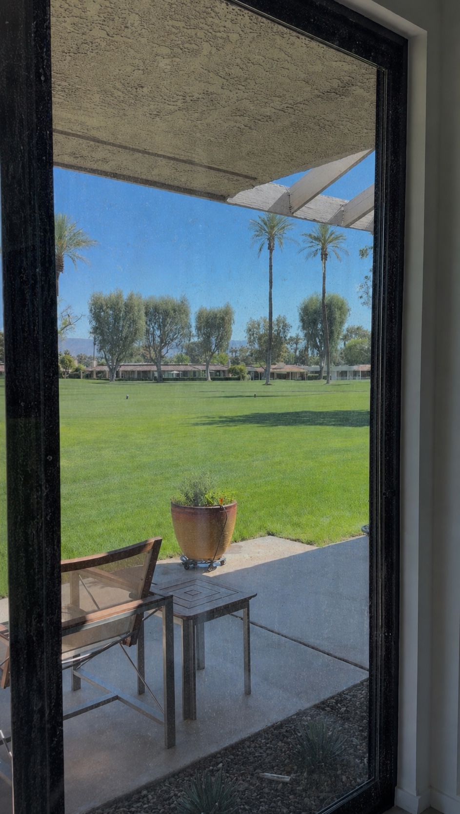 Sliding glass door before cleaning — streaks and smudges on the glass making the view hazy