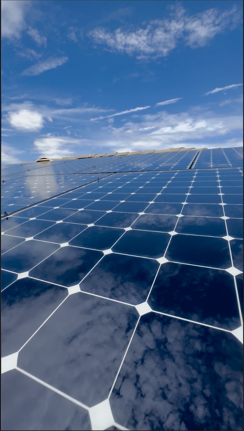 Freshly cleaned solar panels reflecting clouds and the Coachella Valley sky